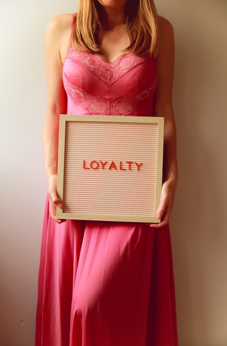 Woman holds a sign that says "loyalty".